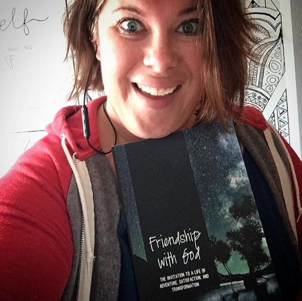 Kimberly holding a copy of Friendship with God
